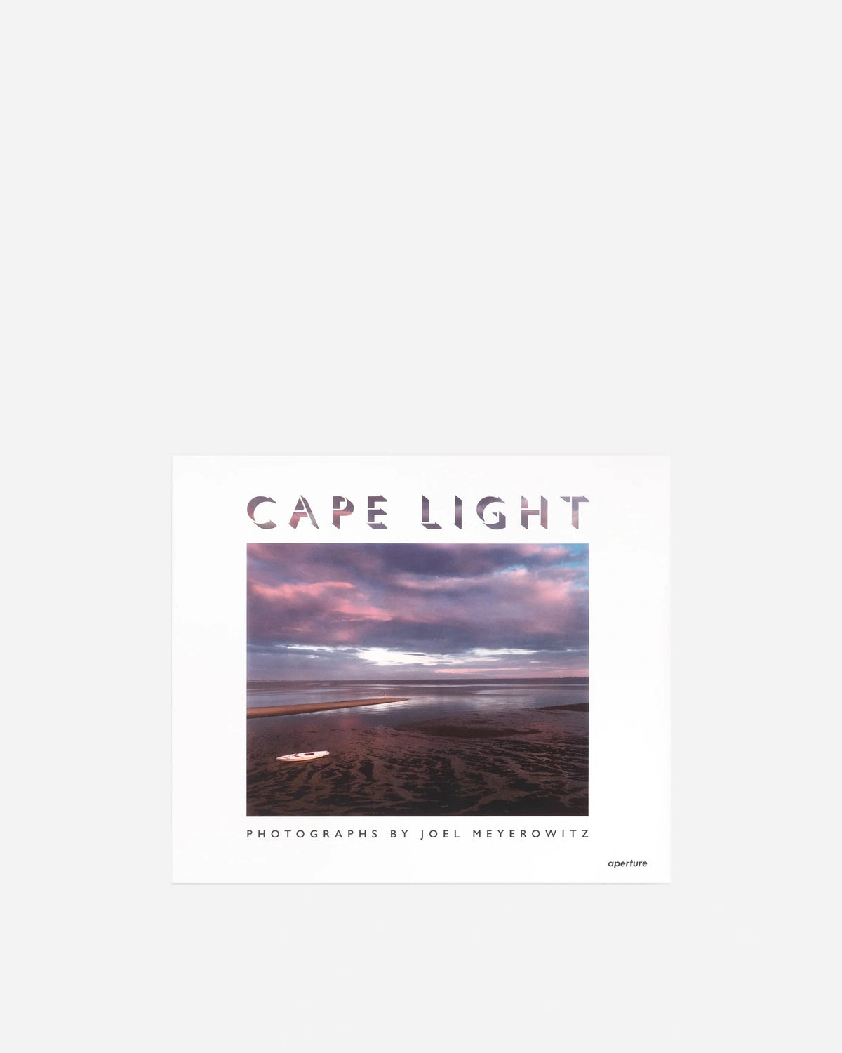 A square art print or book cover titled 'CAPE LIGHT' with a central landscape photograph showing a beach and cloudy sky in pink, purple, and blue tones. Text below reads 'PHOTOGRAPHS BY JOEL MEYEROWITZ' and 'aperture' appears at the lower right.